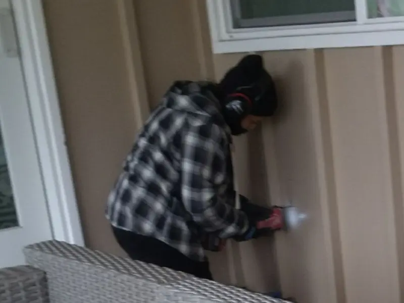 Professional electrician installing an exterior outlet in Albion